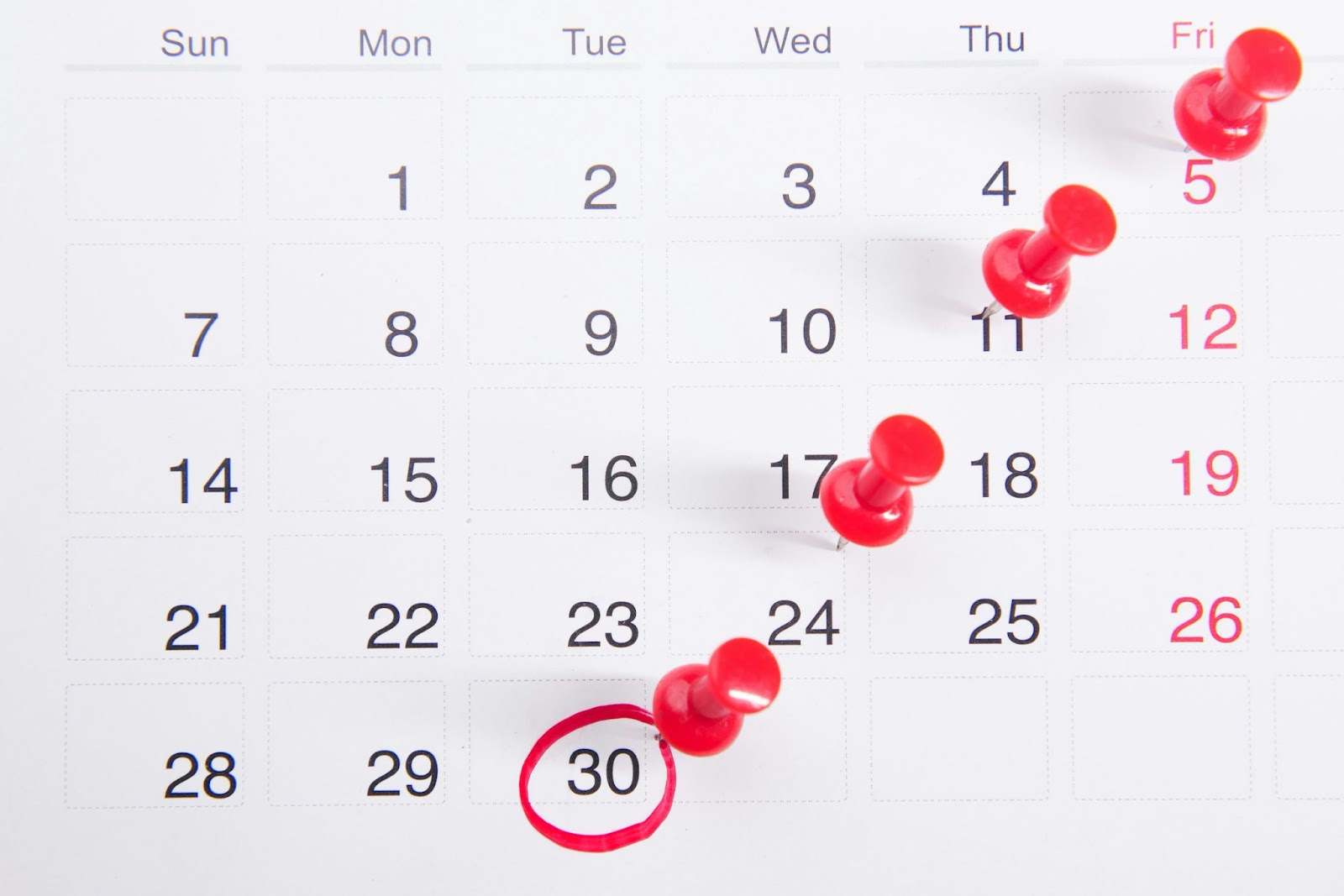 Calendar with red pins on kay dates