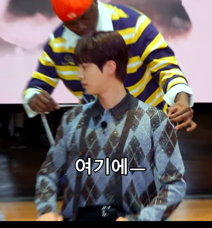 This contains an image of BTS Jin's during his shoulder measurements