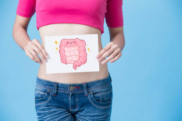 Person holding a cartoon-style digestive system illustration, symbolizing healthy gut and constipation relief.
