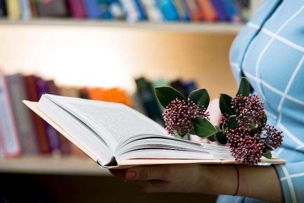 Woman holding a book with flowers