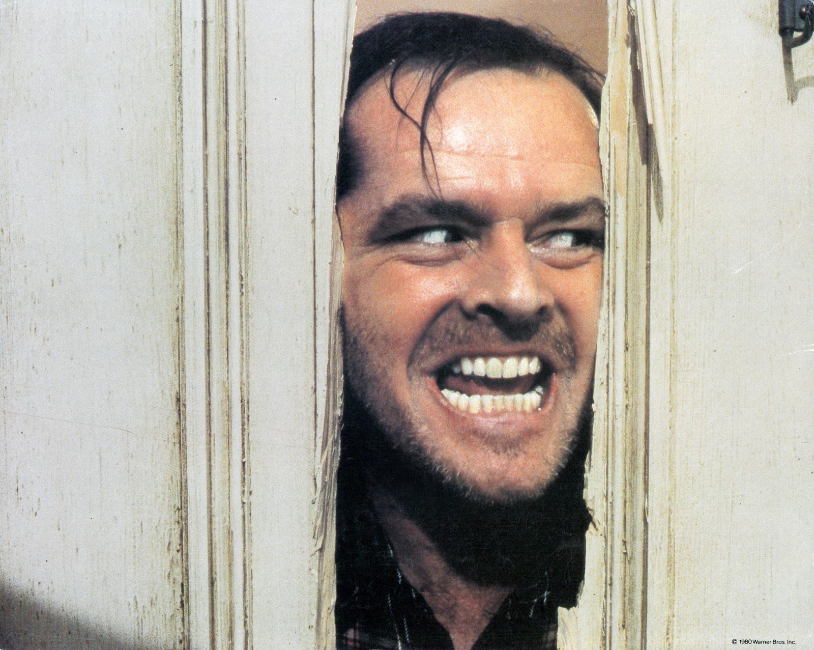 Jack Nicholson peering through the door in lobby card for the film "The Shining," in 1980 | Source: Getty Images