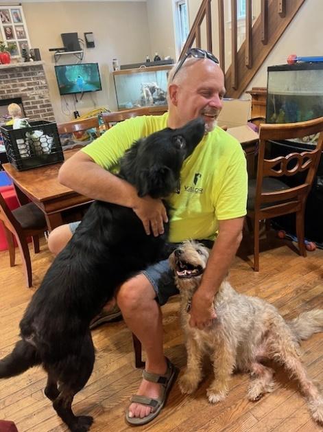 A person holding two dogs

AI-generated content may be incorrect.
