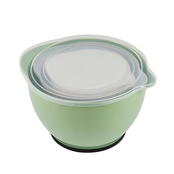 A set of green nesting mixing bowls with matching clear lids on a white background.