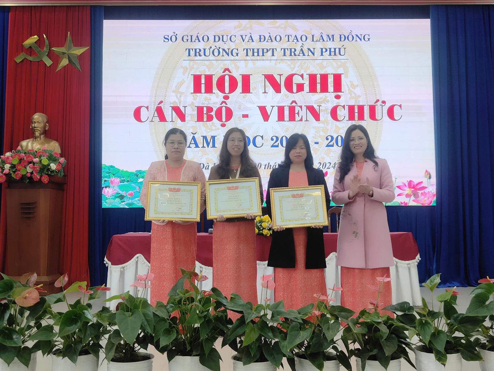 A group of women holding certificates

Description automatically generated
