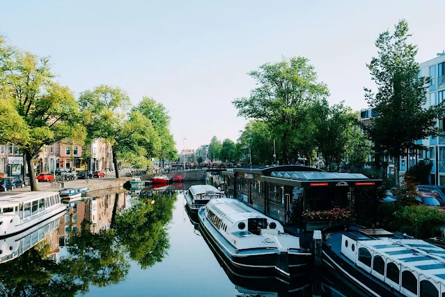 canal with lots of canal boats all the way alone