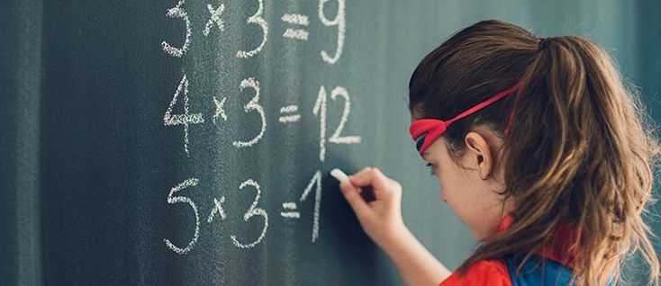 Young girl solving maths probelms