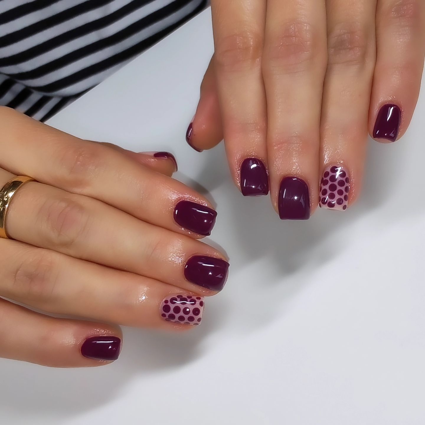 Close-up of hands with fall nail design having Deep Jewel Tones