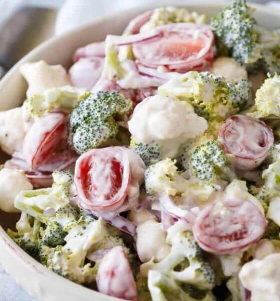 Christmas salad with broccoli and tomatoes in white bowl