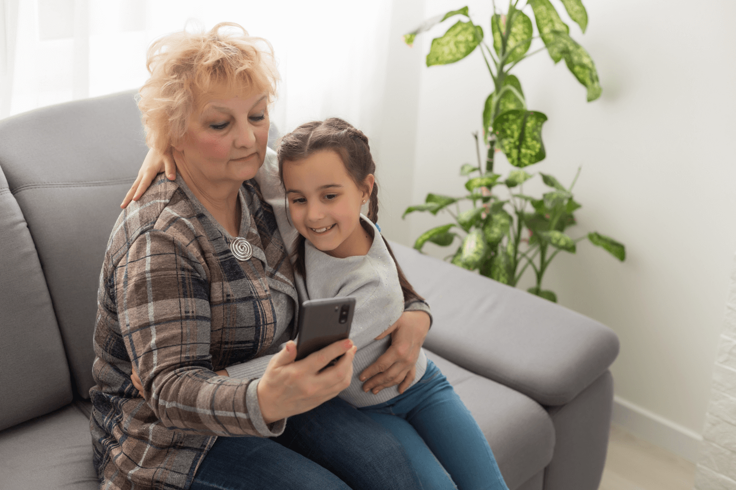 Grandmother holding her granddaughter as they take a photo together