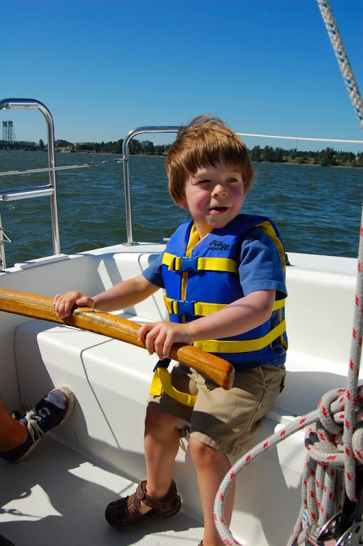 Children’s life jackets featuring grab handles, reflective strips, and bright colors for increased safety and visibility in water.