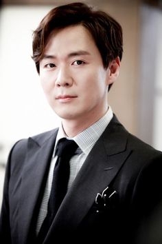 This contains an image of Yeon Jung-hoon putting on suit