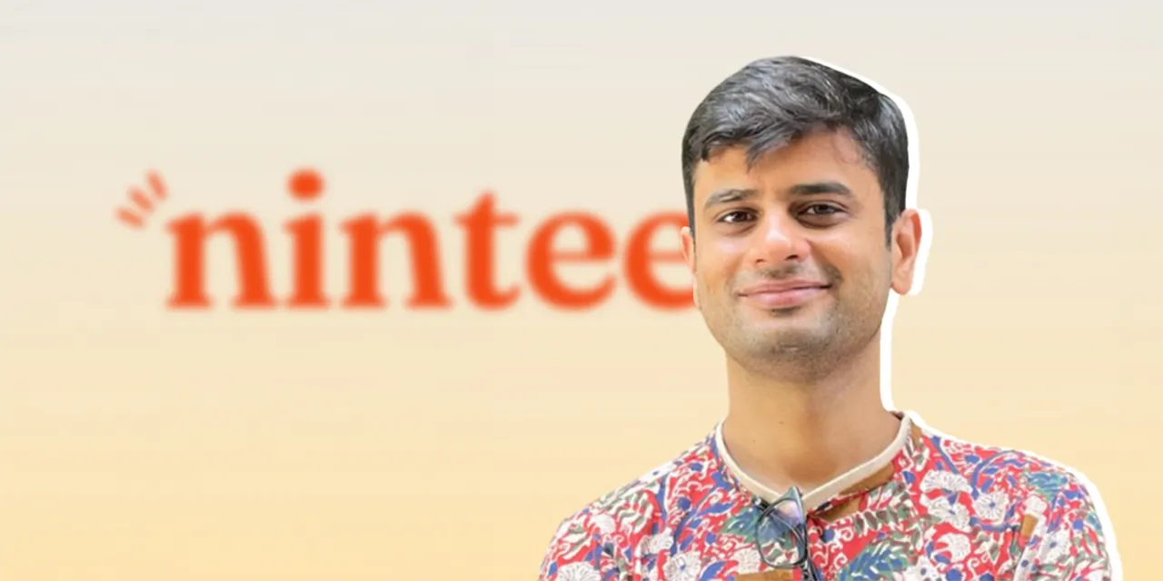 Nintee founder with Nintee logo in the background