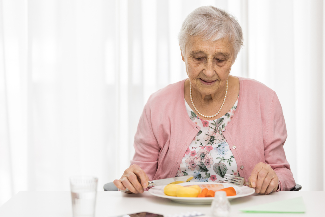 A senior woman eating essential nutrients