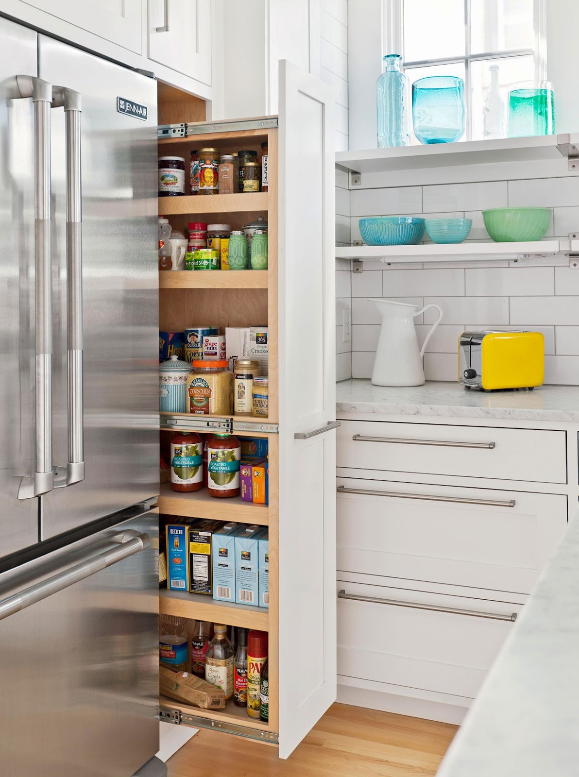 Narrow pull-out pantry revealing organised storage space.