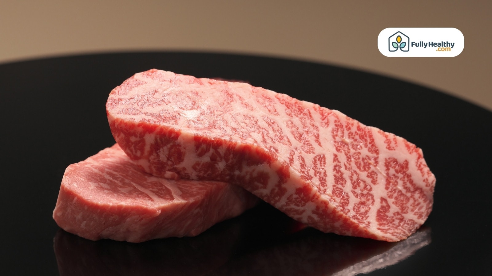Two thick marbled Wagyu beef steaks on a black surface