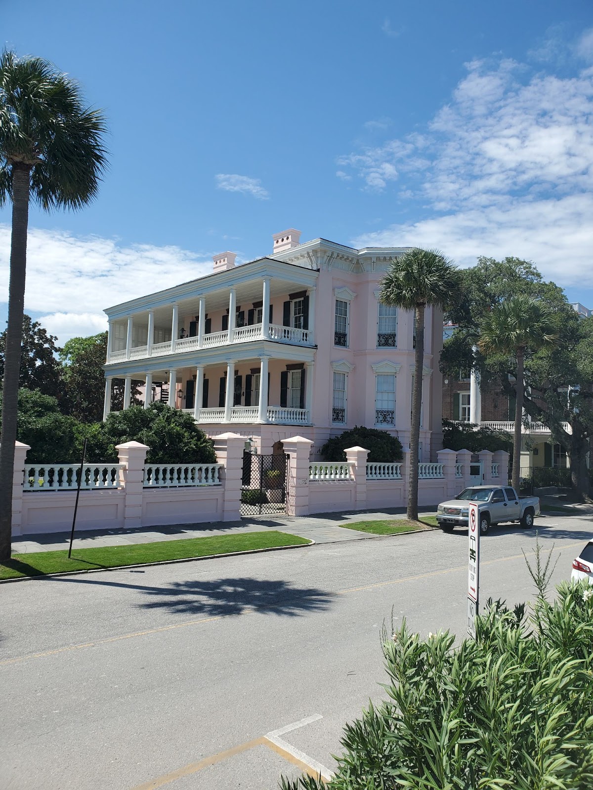 A grand old pink house with privacy wall in Charleston, South Carolina.