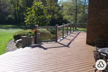 when to hire a michigan deck installer composite decking space with glass panel railings and planter box custom built okemos