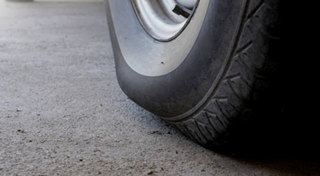 Close-up of a vehicle tire, emphasizing safety and legal concerns for tire fitment.