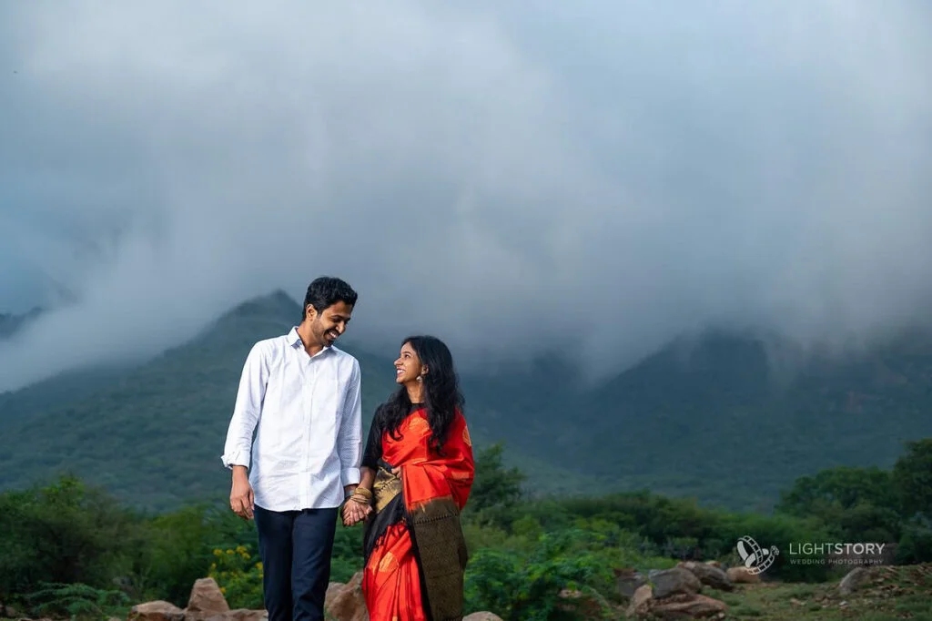 Couple enjoying a joyful walk in the mountains, surrounded by fog and greenery in Coimbatore