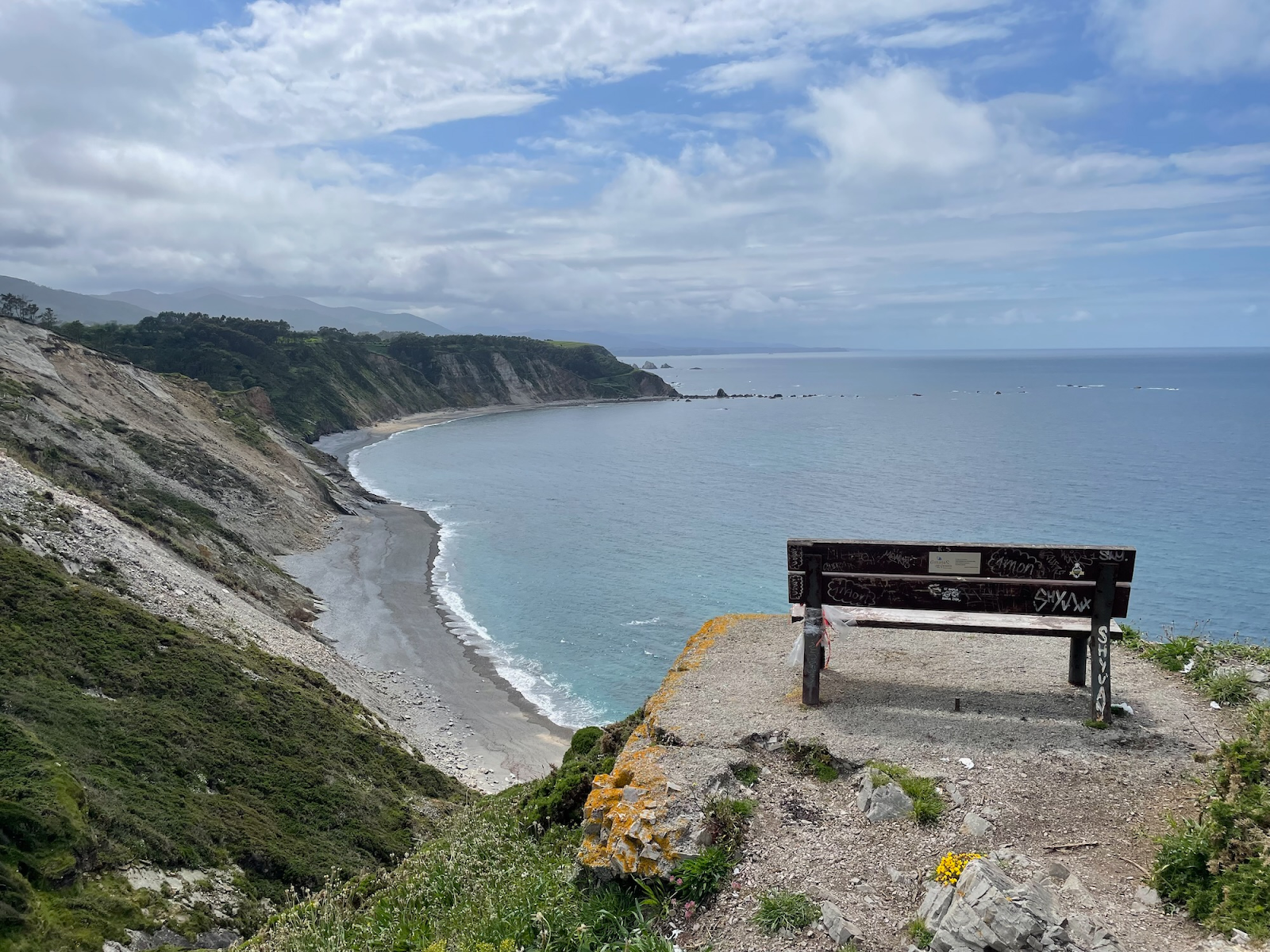 A photo of a bench overlooking a seacoast