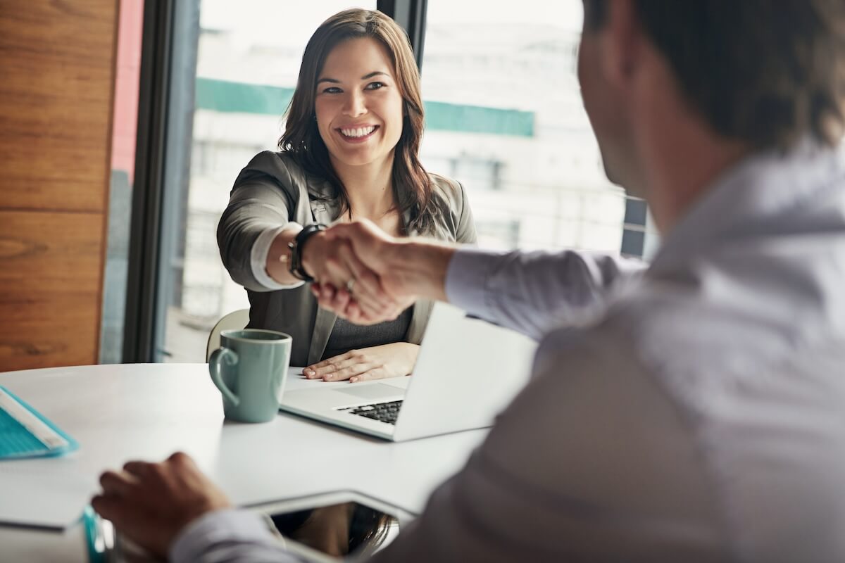 Onboarding checklist: entrepreneur shaking hands with an employee