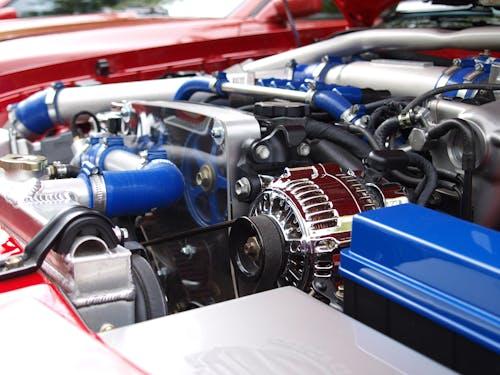 Free Detailed view of a clean modern car engine with vibrant colored components and sleek design. Stock Photo