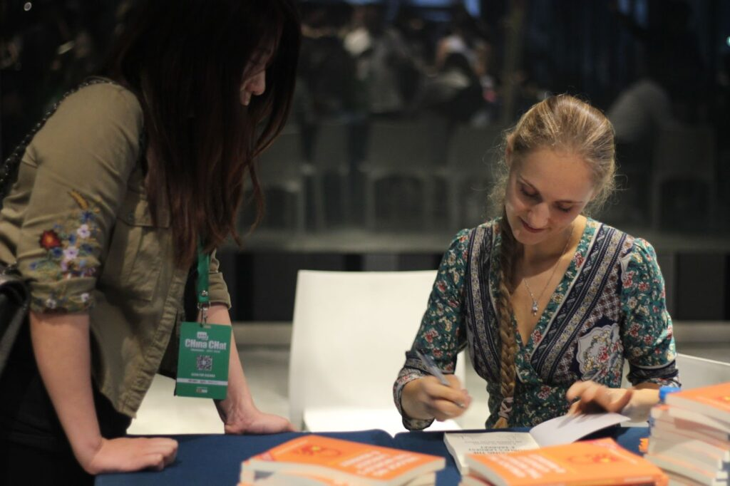 Ashley Dudarenok signing books at a China event.
