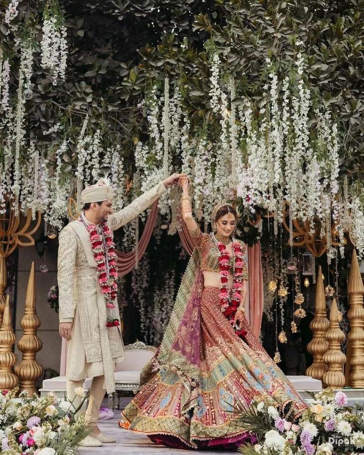 Wedding couple dancing together in the mandap, celebrating their special moment during the ceremony.