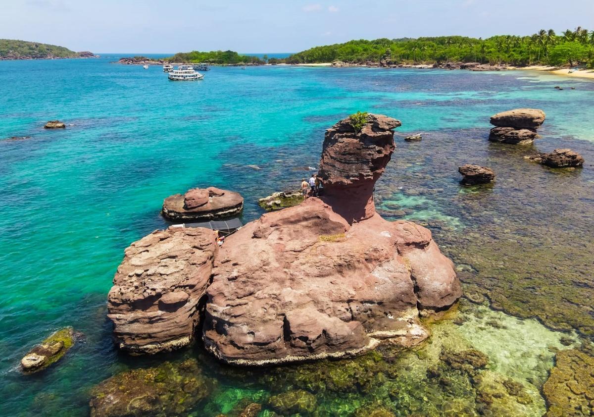 A rocky island in the water

Description automatically generated