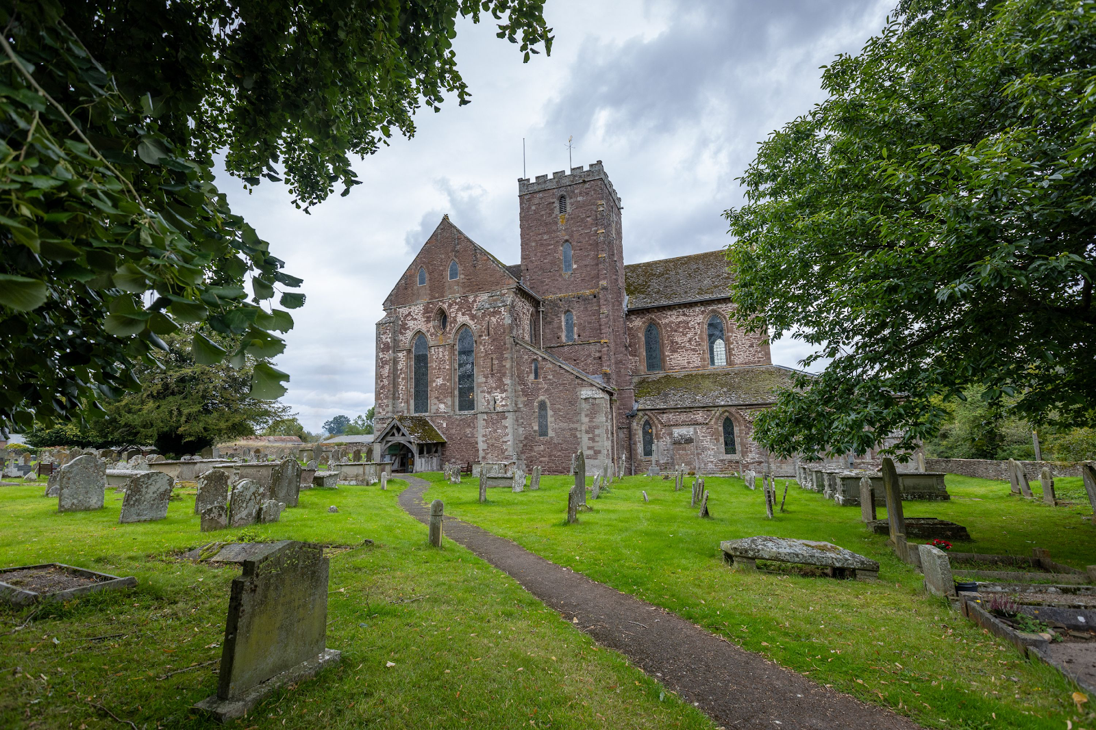 A stone building with a cemetery

Description automatically generated