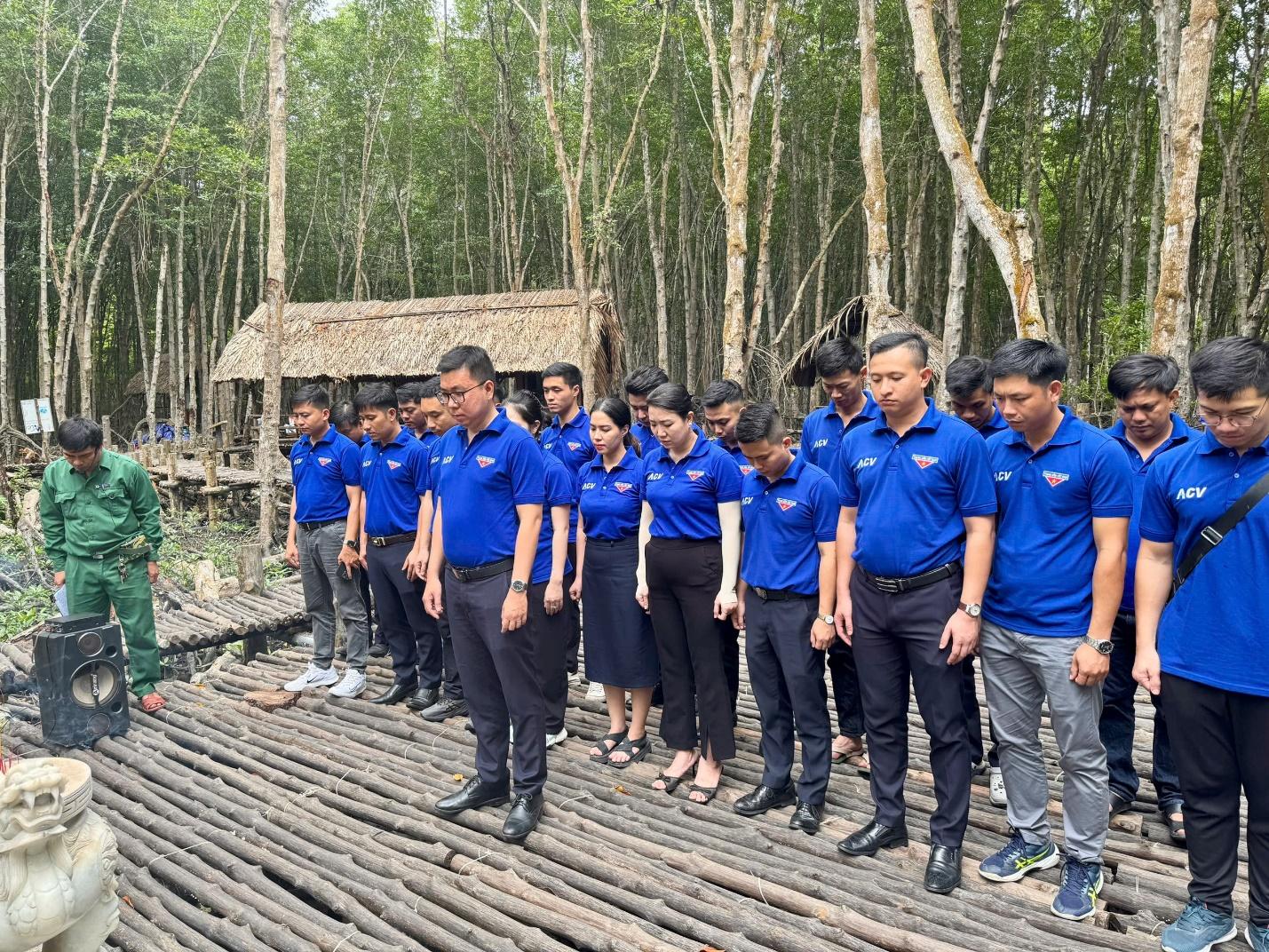 A group of people standing on a wooden platformDescription automatically generated