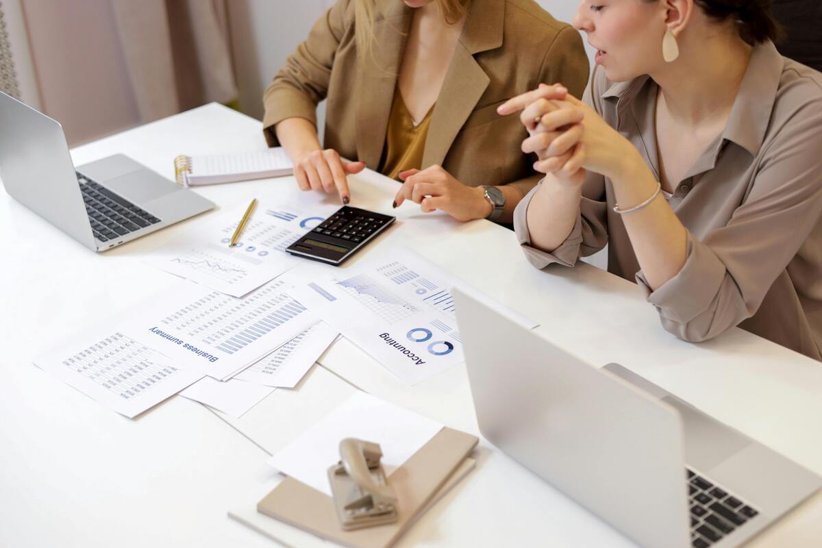 Two women calculating cloud cost