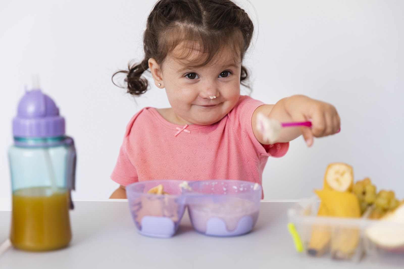 A little girl offering her food