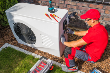 essential winterizing tips for your michigan home maintenance employee fixing heating system custom built okemos