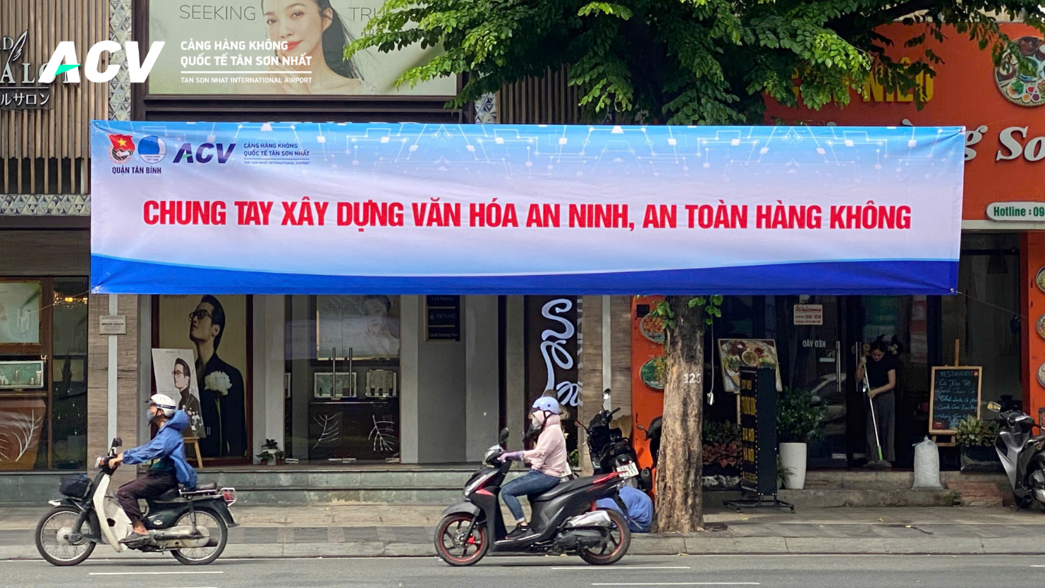 A person riding a scooter under a bannerDescription automatically generated