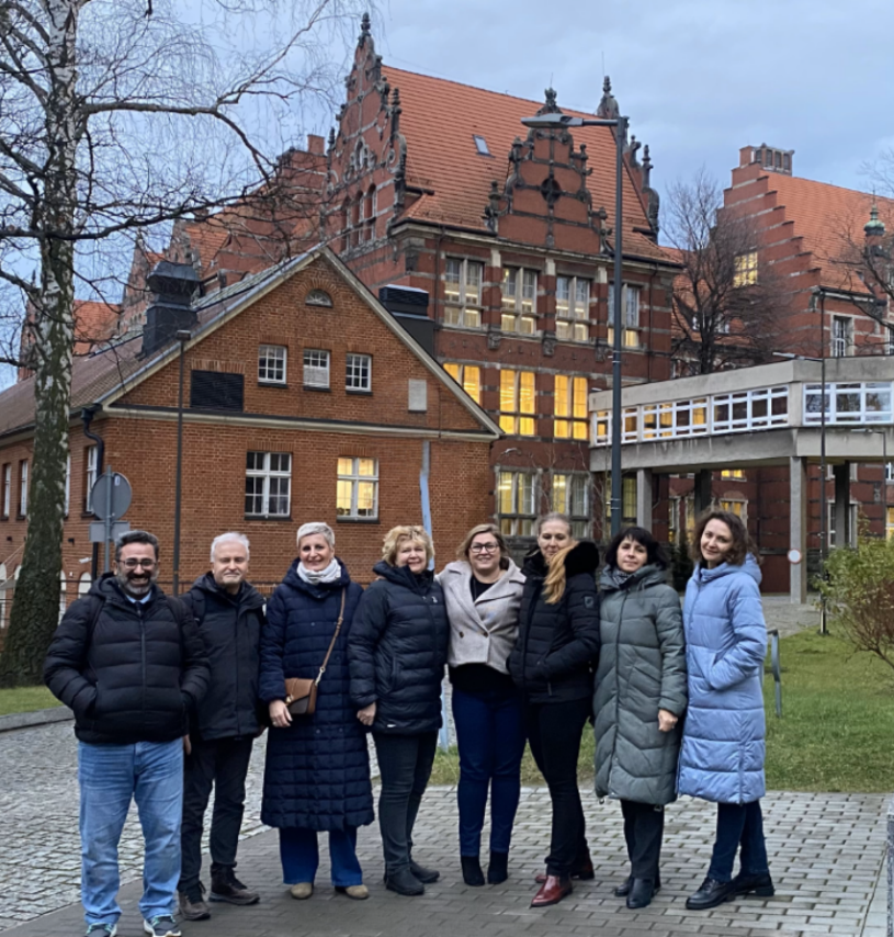 A group of people posing for a photo

Description automatically generated