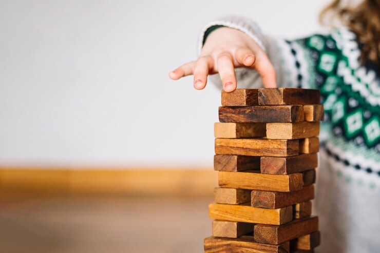 lady stacking wooden blocks
