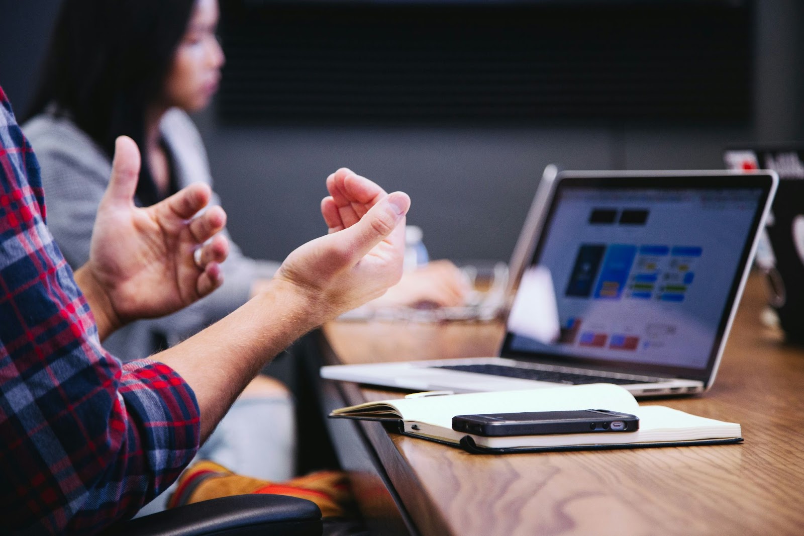 Person communicating with a colleague using his smart devices