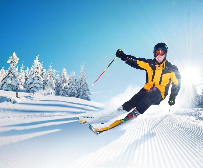 A person skiing down a slope  Description automatically generated