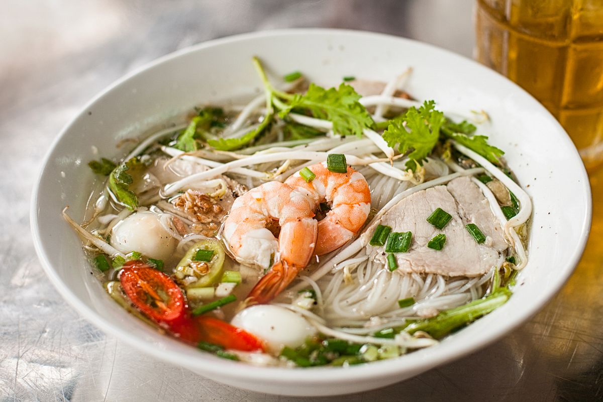 Kuy Teav is often garnished with lime, chili, and bean sprouts