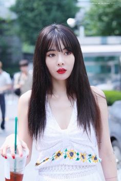 This contains an image of HyunA holding a cup of coffee