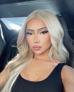 This contains an image of Nikita Dragun wearing a black singlet 