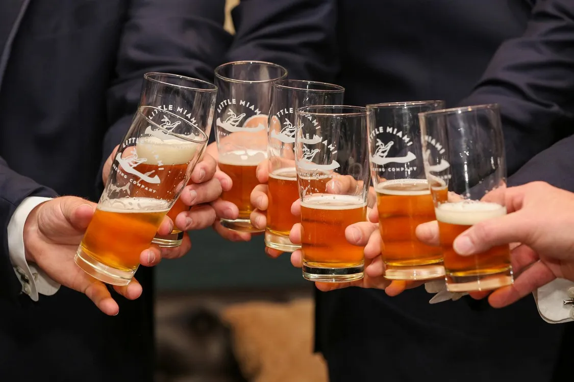 Seven people cheering up the beer glass at LMBC 
