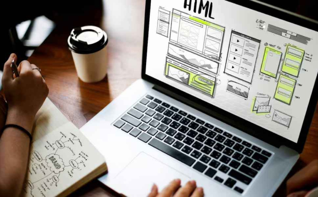 for web development process, A person working on a laptop, with the screen showing a website mockup labelled "HTML". The person is also holding a pen and a notebook with sketches and notes, illustrating the web development process