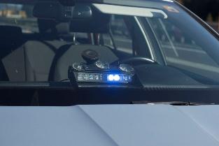 A police car with a light on

AI-generated content may be incorrect.