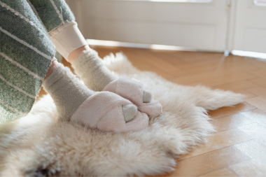 signs that your homes insulation isnt performing well homeowner with slippers and rug custom built michigan