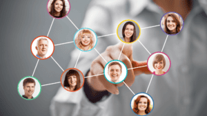 A person touching a screen with a group of people's faces

AI-generated content may be incorrect.