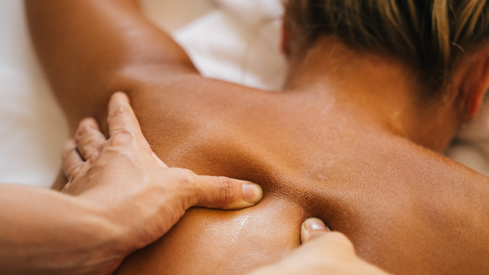 Massage therapist back massaging a woman