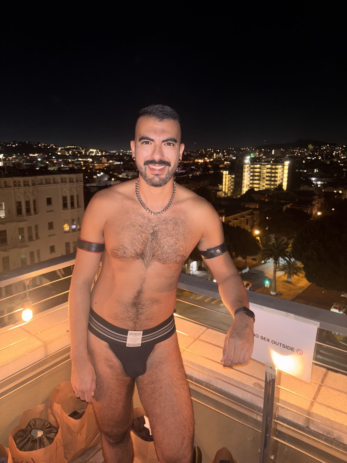 gay xxx porn creator Phil standing outside taking in the san francisco view during a gay sex party happening at Folsom Street fair 2024