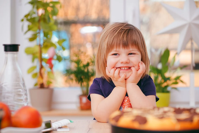 toddler smiling at kitchen table
